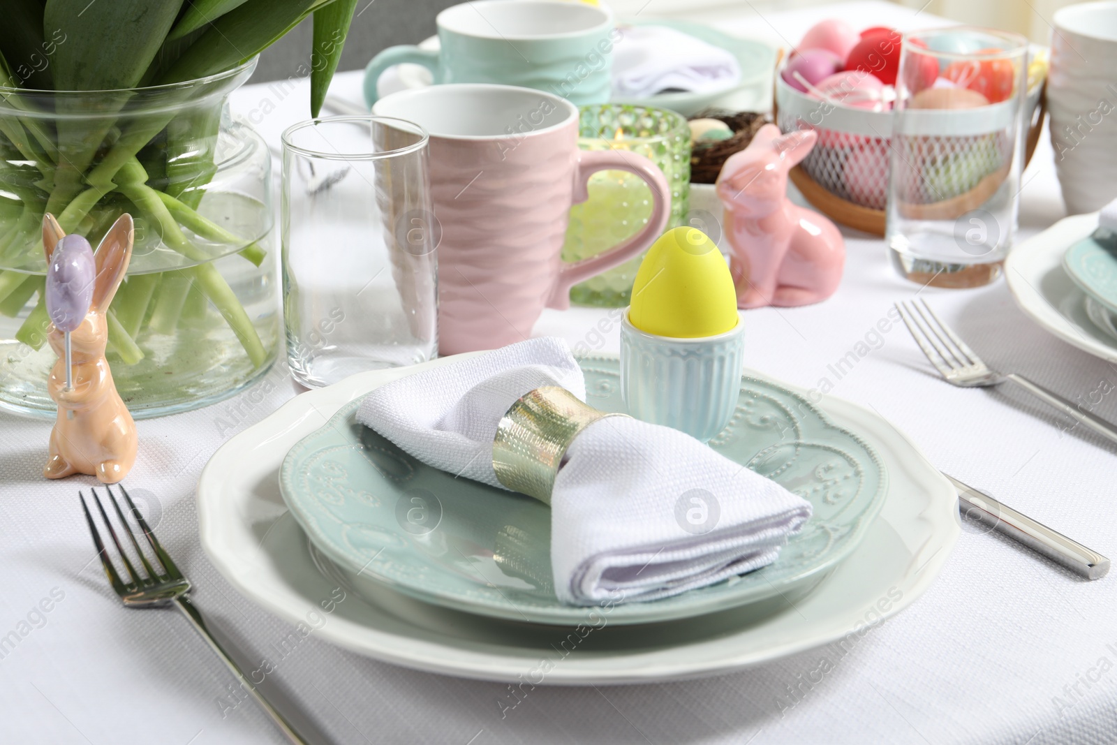 Photo of Easter celebration. Festive table setting with painted eggs.