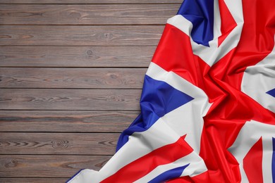 Flag of United Kingdom on wooden background, top view. Space for text