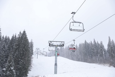 Ski lift at snowy mountain resort. Winter vacation