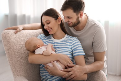 Photo of Happy family. Parents with their cute baby at home