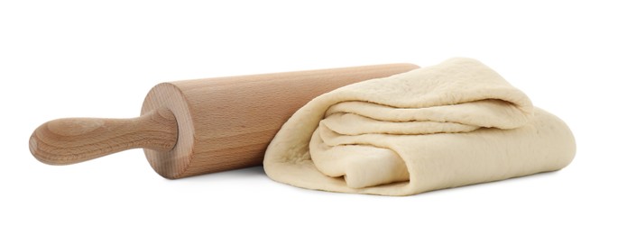 Photo of Raw dough and rolling pin isolated on white