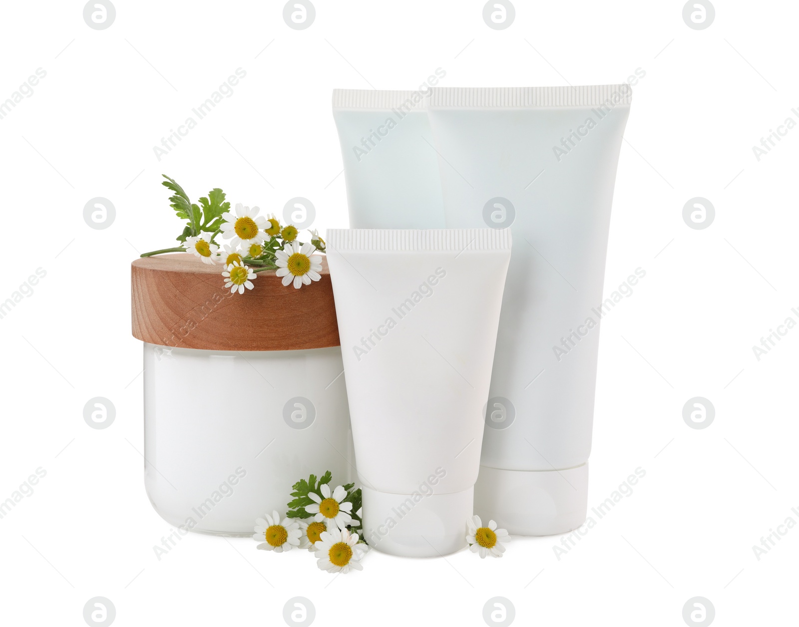 Photo of Different hand care cosmetic products and chamomiles on white background