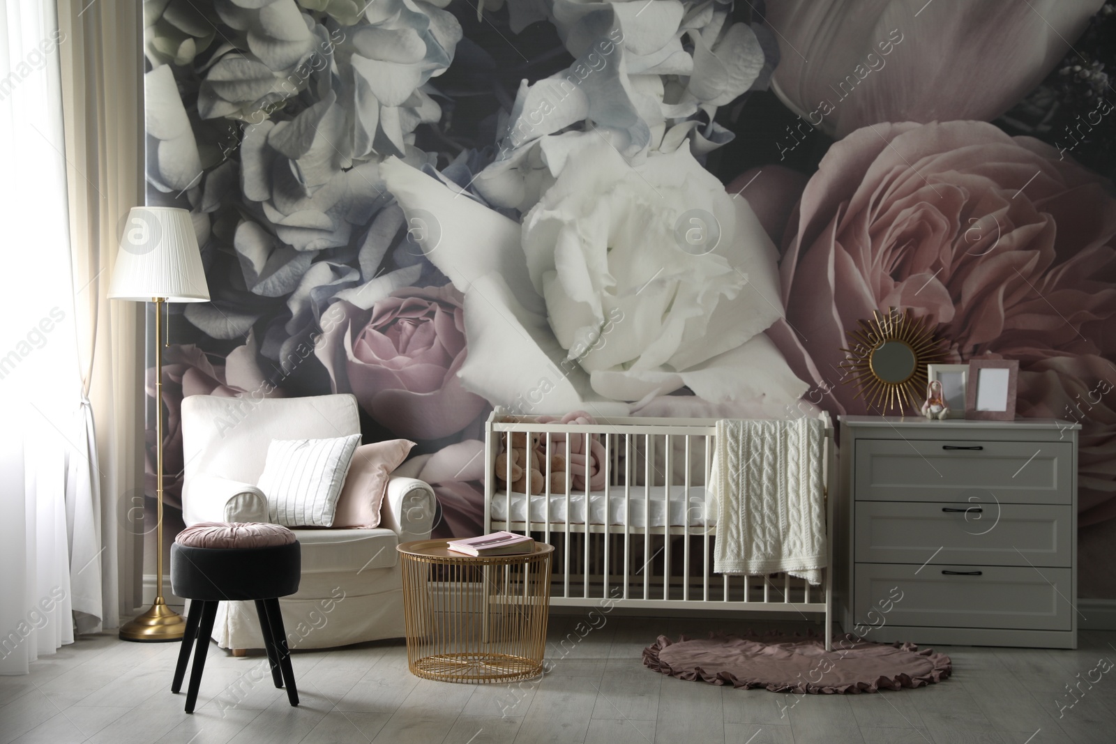 Photo of Baby room interior with stylish crib and floral wallpaper