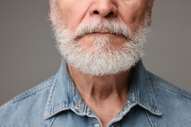 Photo of Man with mustache on grey background, closeup