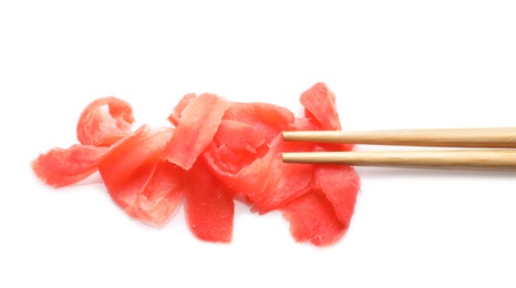 Photo of Piquant pickled ginger and chopsticks on white background, top view. Delicious sauce condiment