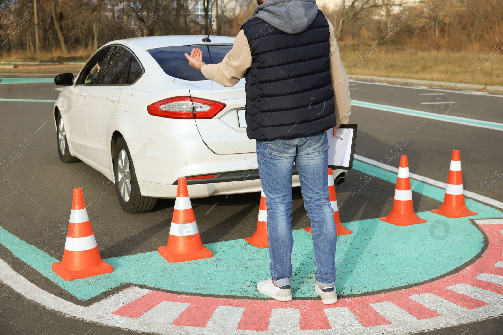 Photo of Instructor and student in car during exam on test track. Driving school