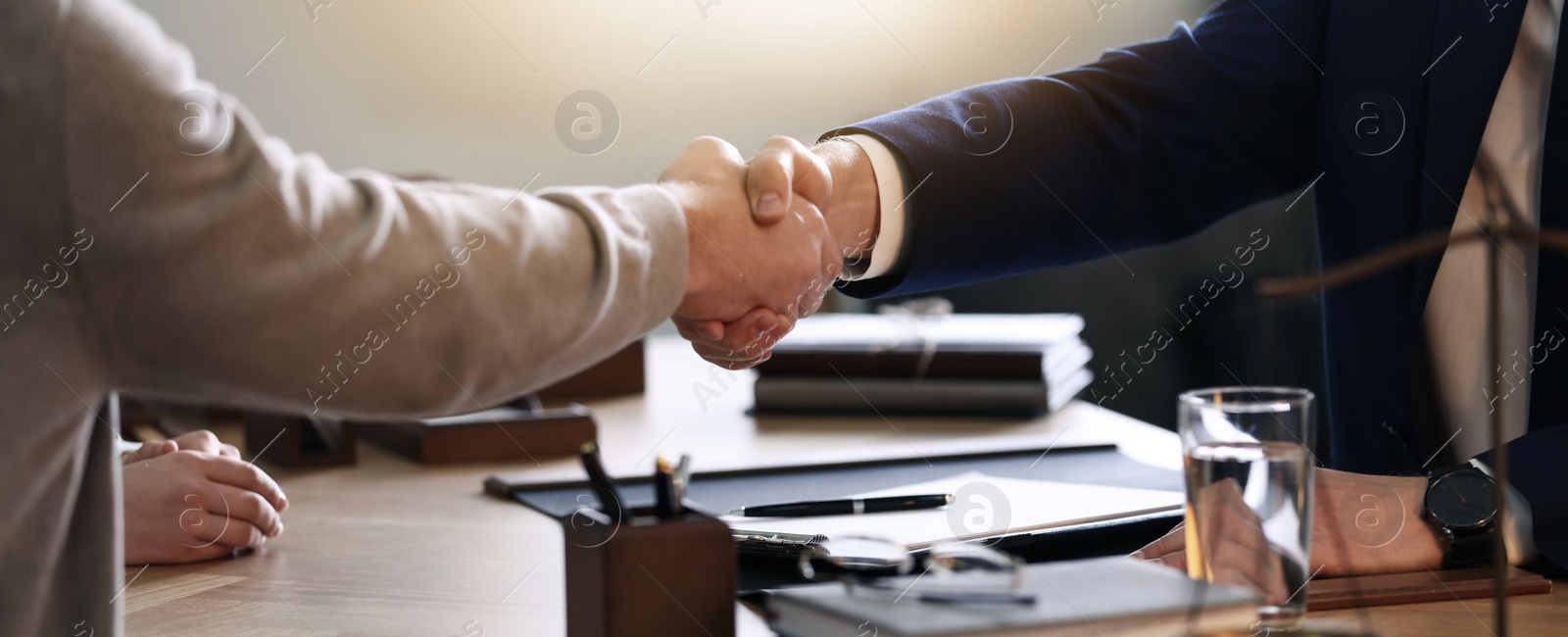 Image of Male lawyer working with clients in office, closeup. Banner design