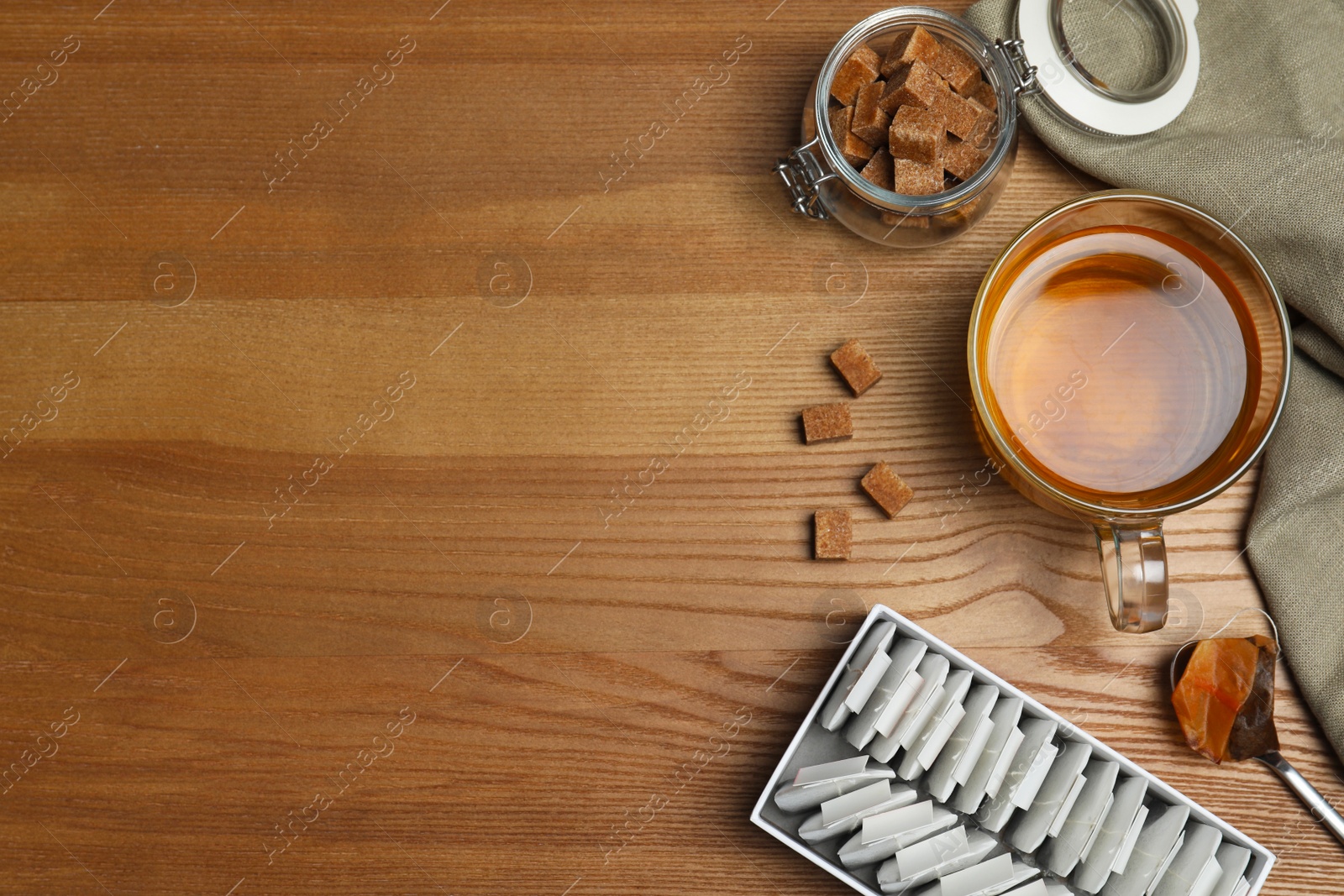 Photo of Flat lay composition with cup of tea and space for text on wooden background