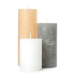 Three color wax candles on white background