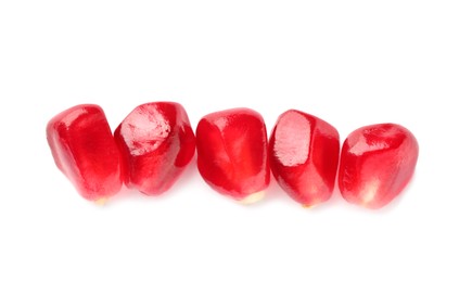 Photo of Tasty pomegranate seeds on white background, top view