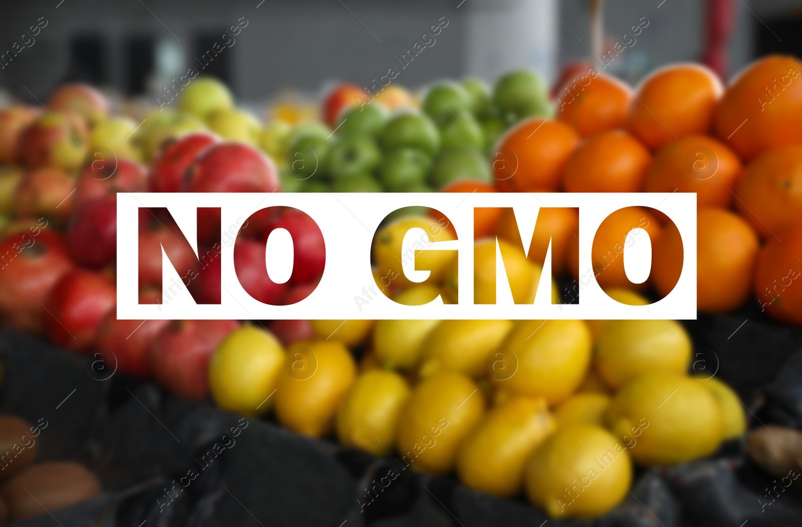 Image of GMO free products. Blurred view of fresh fruits on counter at wholesale market