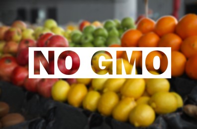 Image of GMO free products. Blurred view of fresh fruits on counter at wholesale market