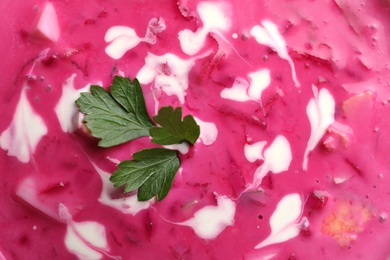 Delicious cold summer beet soup as background, closeup