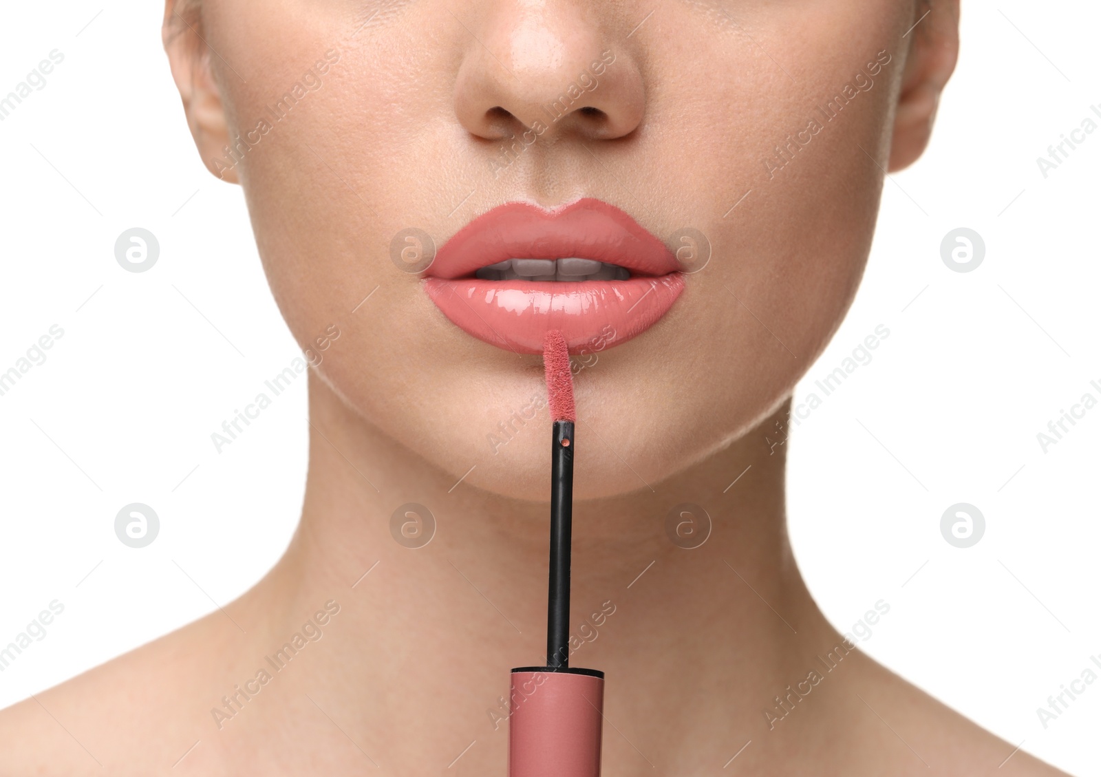 Photo of Woman applying lip gloss on white background, closeup