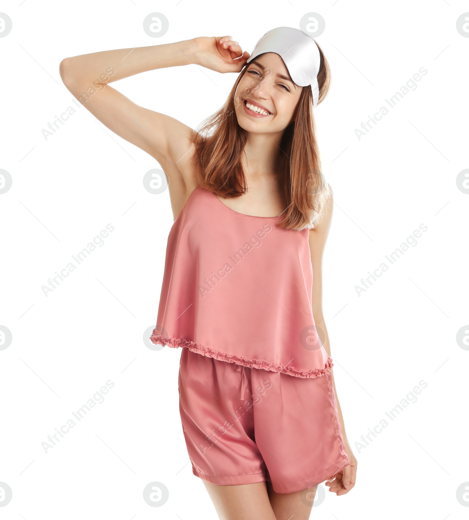 Photo of Beautiful woman wearing pajamas and sleep mask on white background. Bedtime