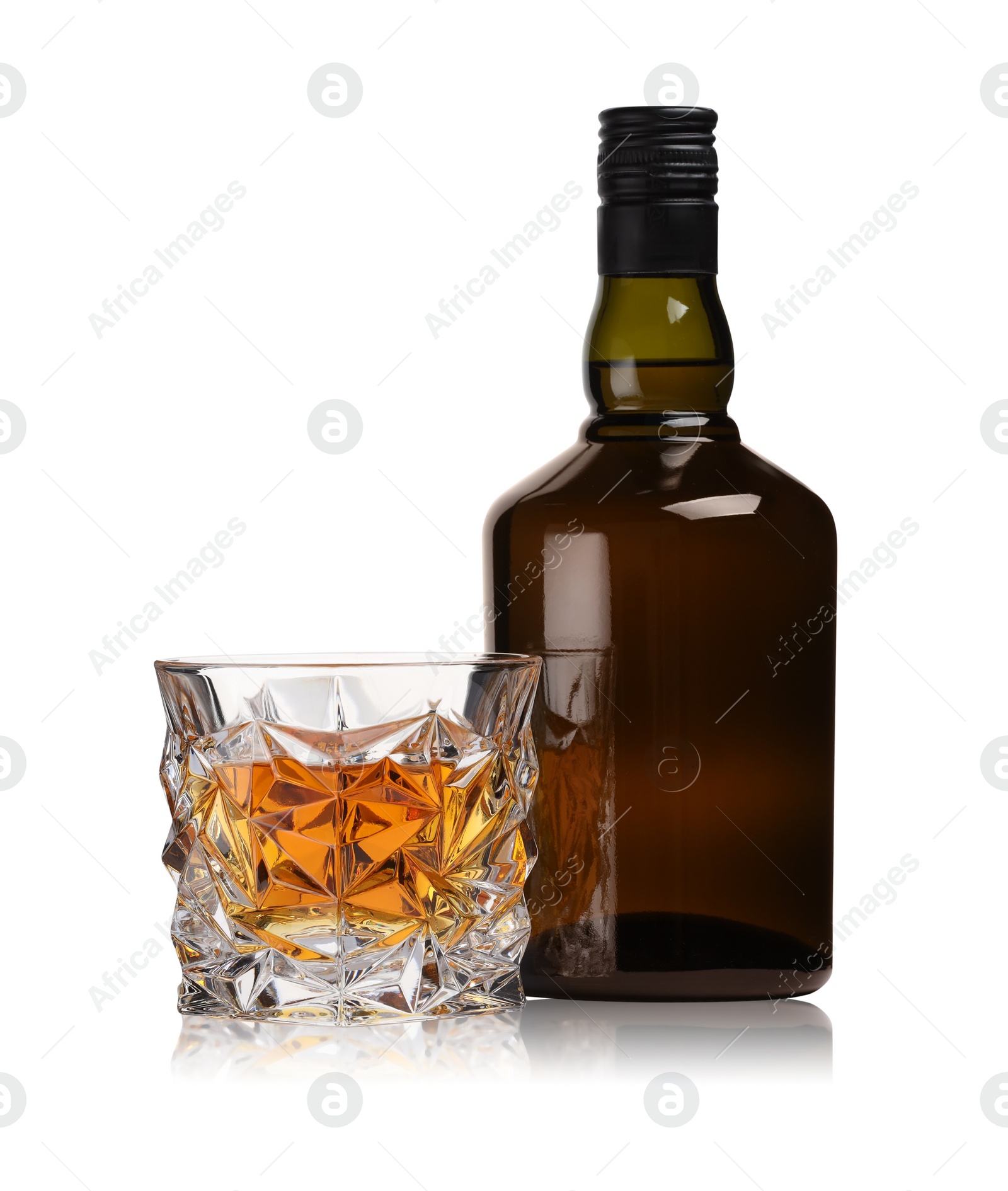 Photo of Glass and bottle of whiskey isolated on white