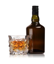 Photo of Glass and bottle of whiskey isolated on white