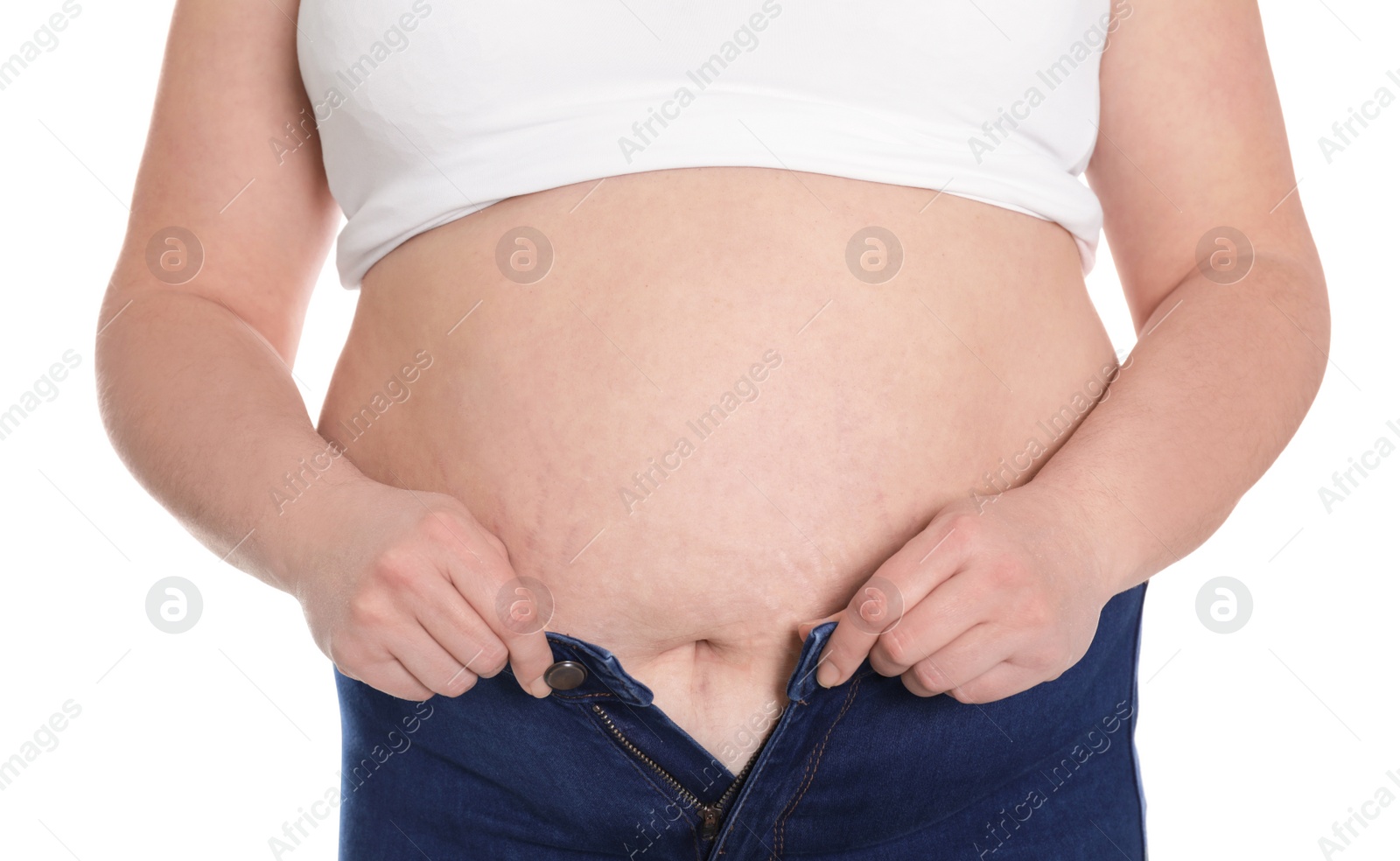 Photo of Overweight woman trying to wear tight jeans isolated on white, closeup