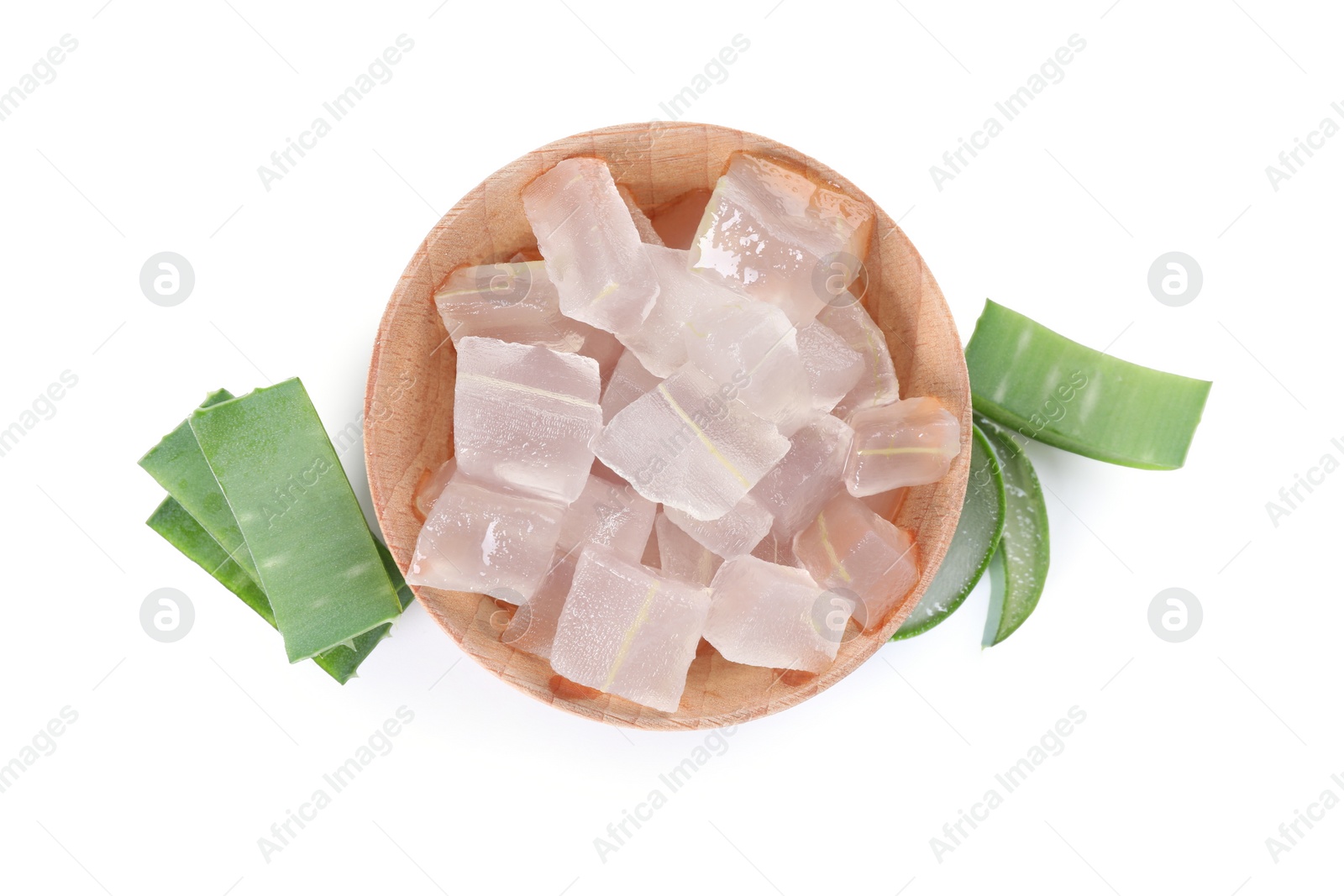 Photo of Peeled aloe vera in bowl and pieces of green plant isolated on white, top view