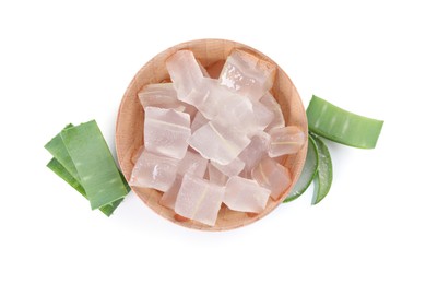 Photo of Peeled aloe vera in bowl and pieces of green plant isolated on white, top view