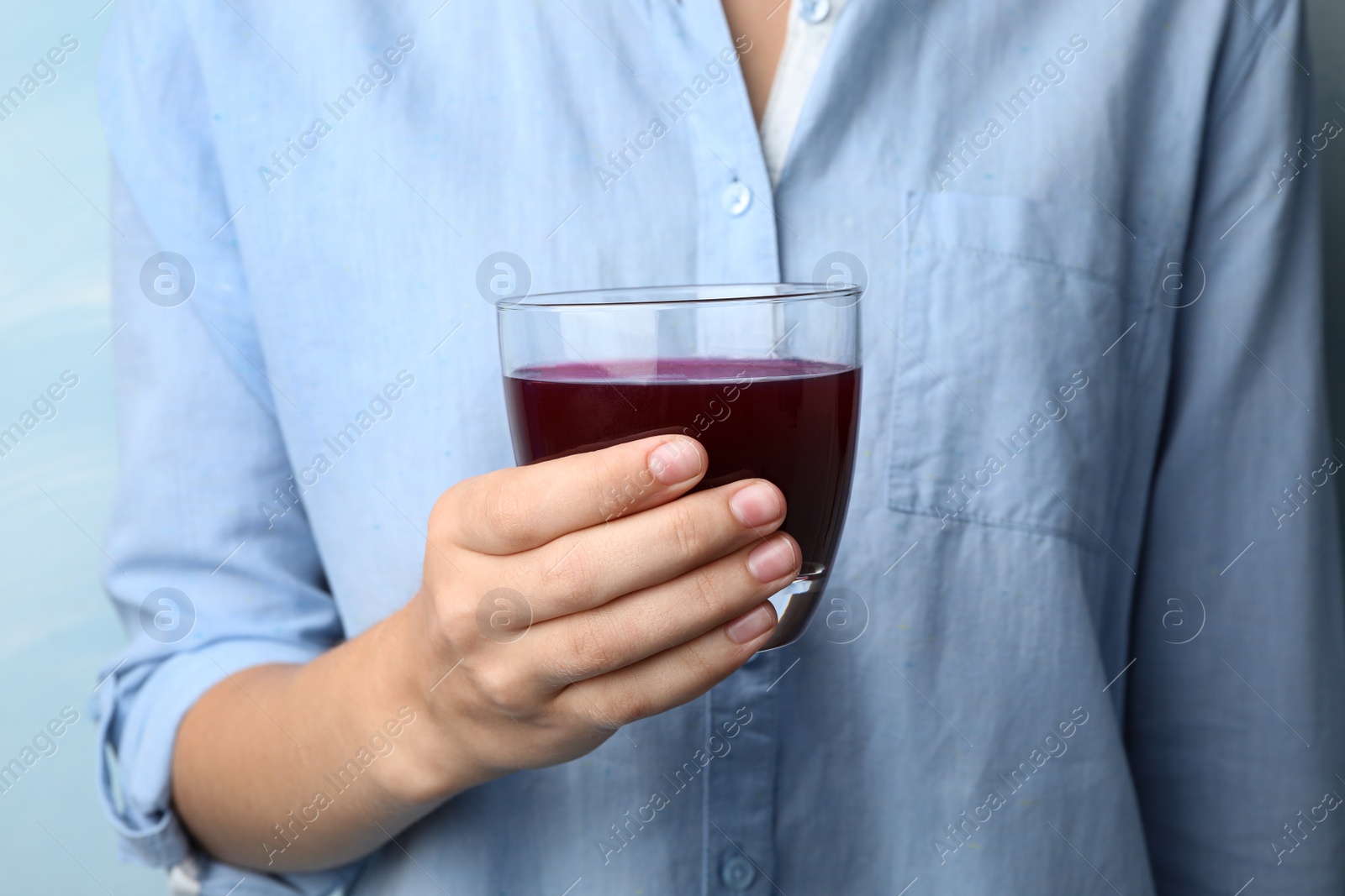 Image of Woman with glass of juice, closeup 