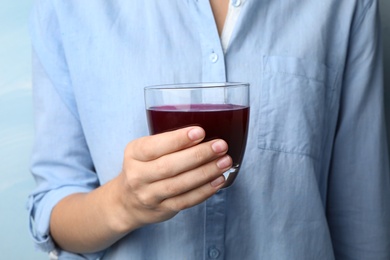 Image of Woman with glass of juice, closeup 