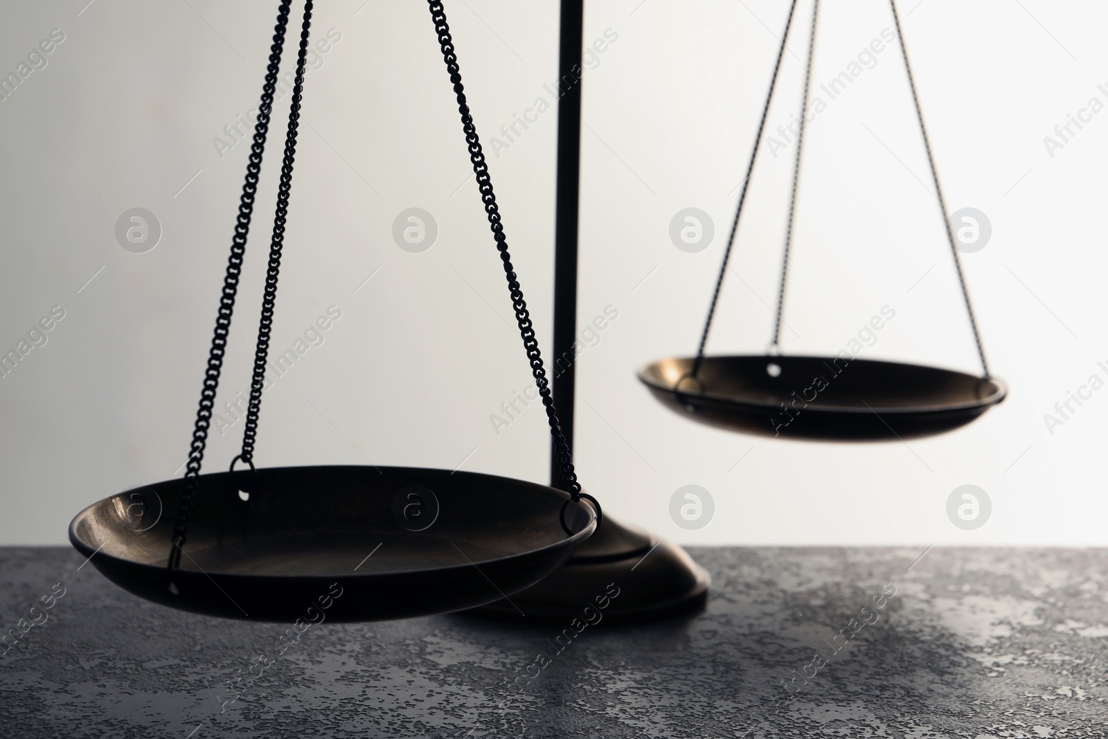 Photo of Scales of justice on table, closeup. Law concept