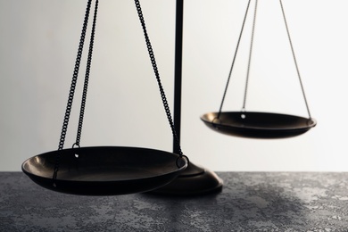 Scales of justice on table, closeup. Law concept