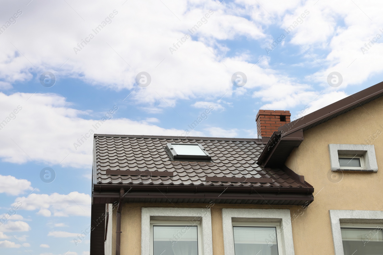 Photo of Beautiful house with color roof against blue sky, low angle view