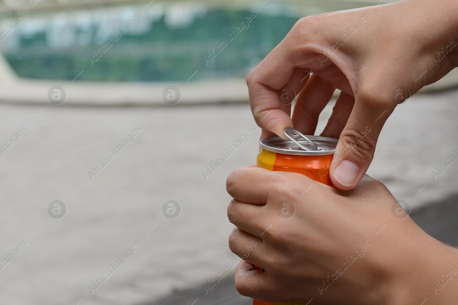 Photo of Woman opening tasty canned beverage outdoors, closeup. Space for text