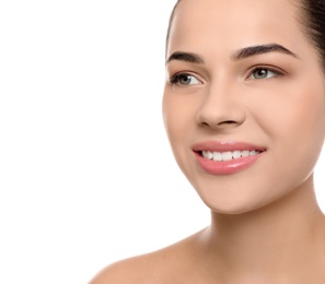 Portrait of young woman with beautiful face and natural makeup on white background, closeup