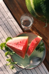 Photo of Flat lay composition with tasty ripe watermelons on wooden table