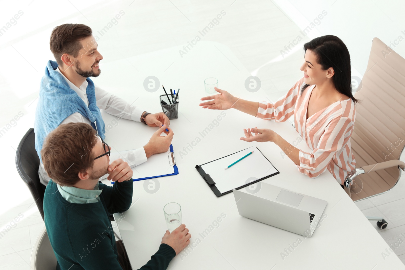 Photo of Human resources manager conducting job interview with applicants in office