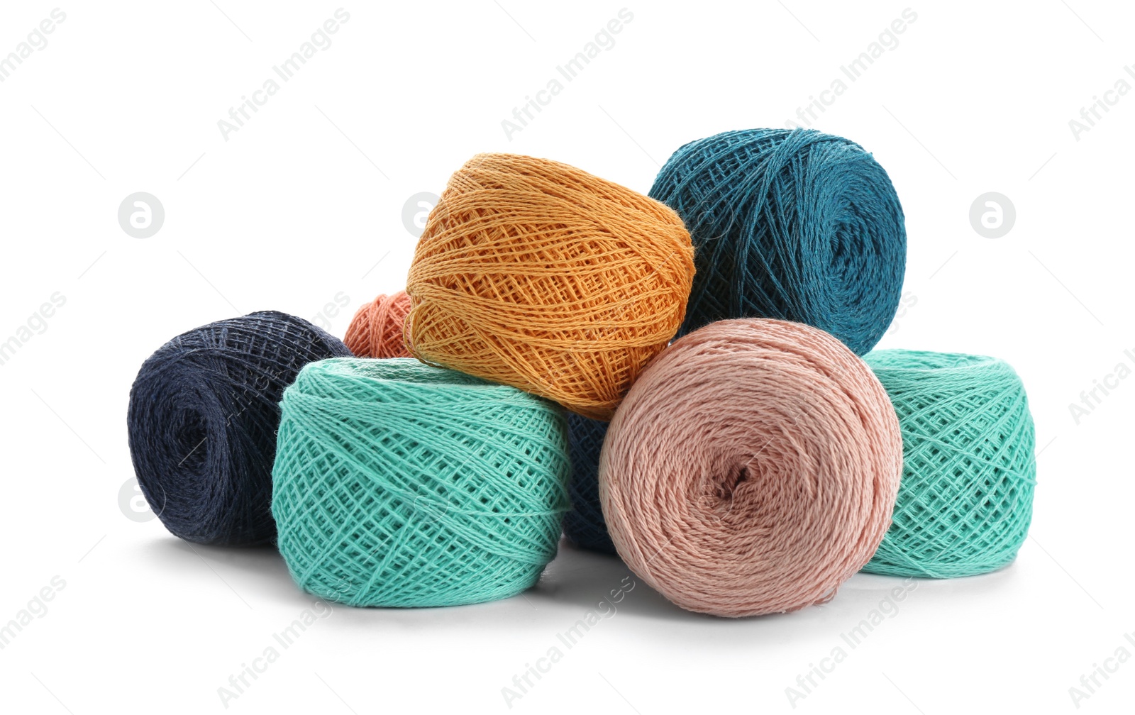 Photo of Clews of colorful knitting threads on white background