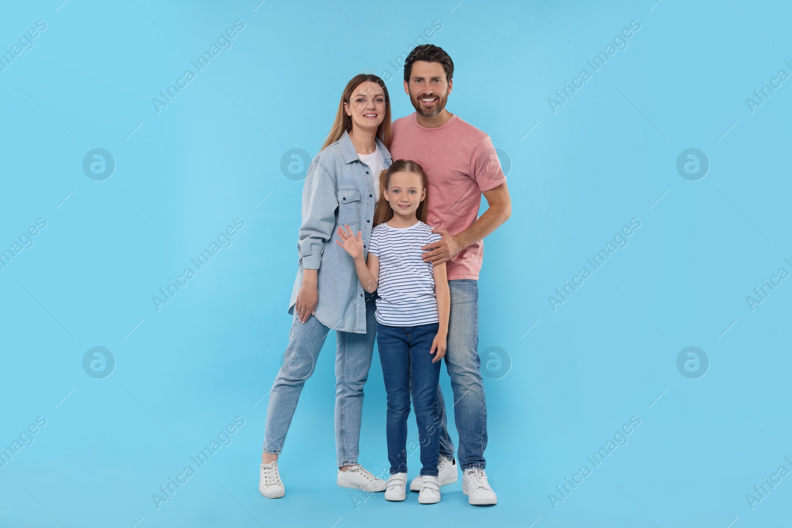 Photo of Happy family together on light blue background