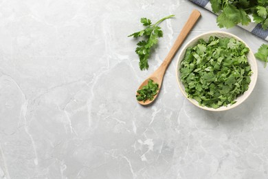 Photo of Fresh green cilantro on light grey marble table, flat lay. Space for text