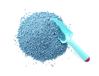 Photo of Pile of granular mineral fertilizer and shovel on white background, top view
