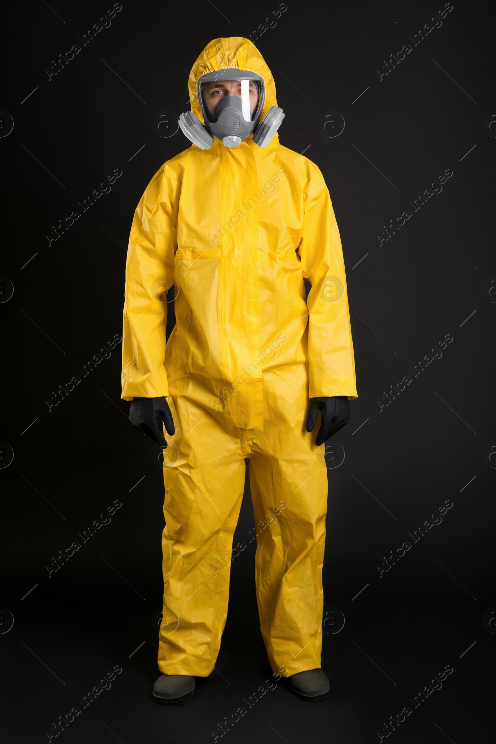 Photo of Man wearing chemical protective suit on black background. Virus research