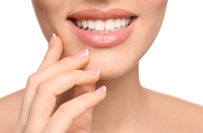 Young woman with beautiful smile on white background, closeup. Teeth whitening