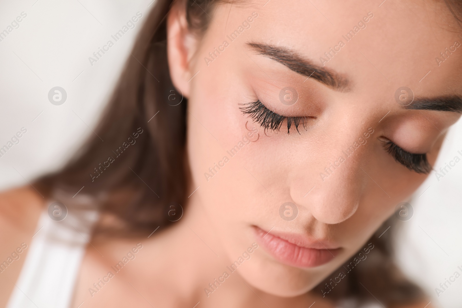 Photo of Young woman with eyelash loss problem, closeup