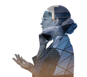 Double exposure of businesswoman talking on phone and office buildings