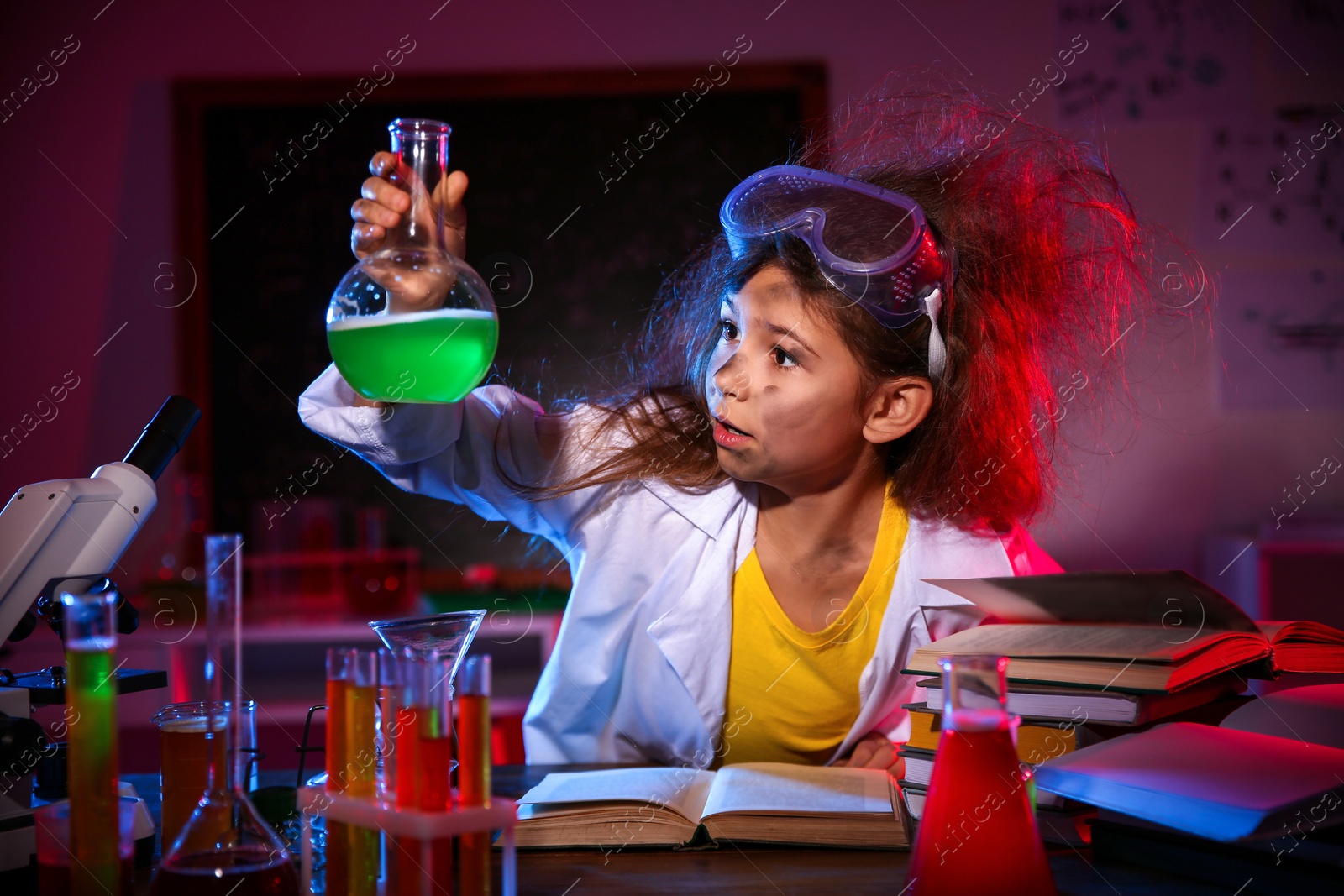 Photo of Child doing chemical research in laboratory. Dangerous experiment