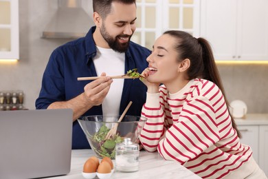 Photo of Happy lovely couple cooking together in kitchen