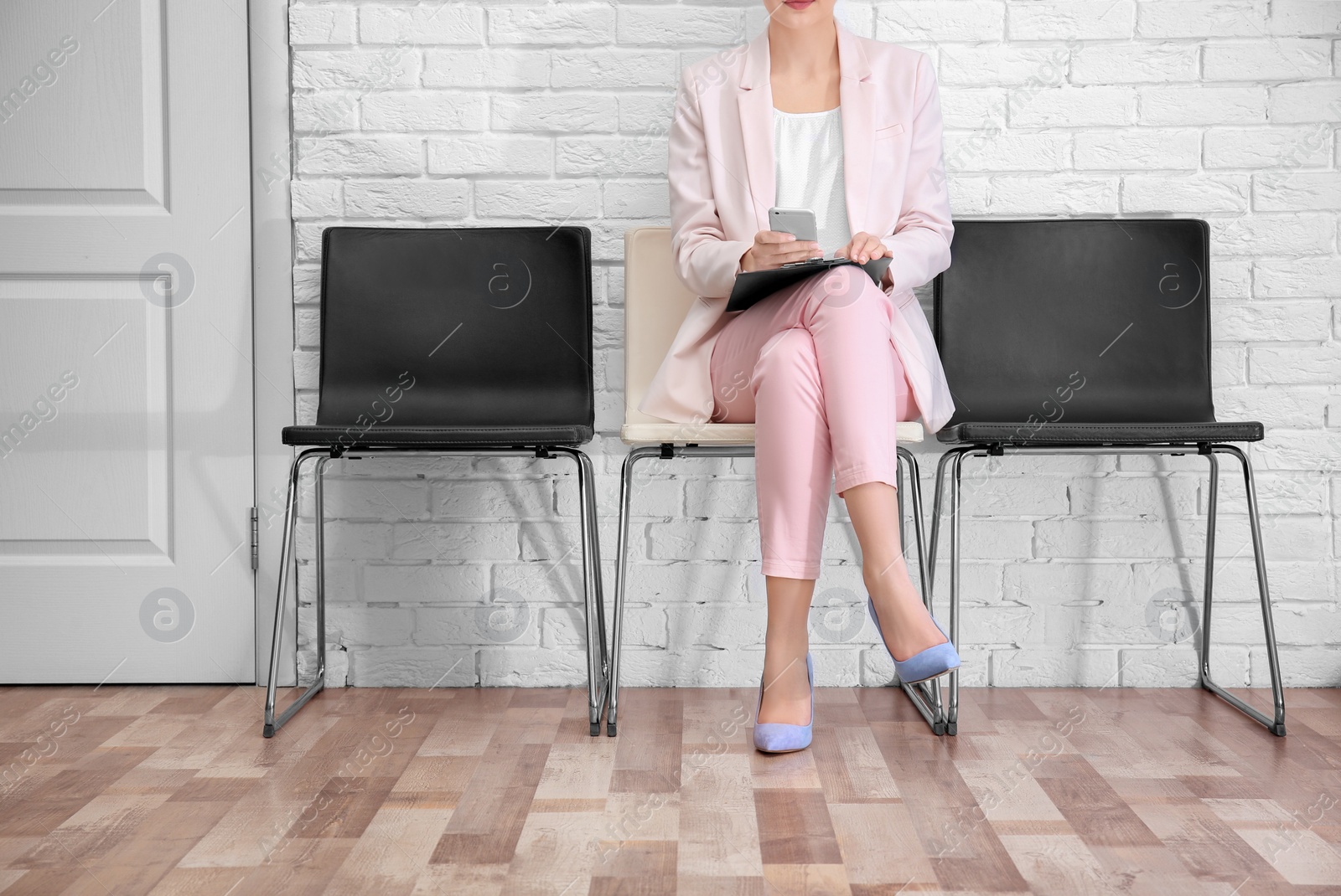 Photo of Young woman waiting for job interview, indoors