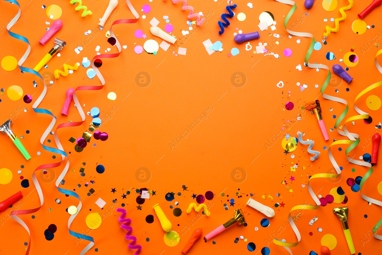 Photo of Frame of carnival items on orange background, flat lay. Space for text