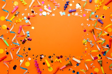 Photo of Frame of carnival items on orange background, flat lay. Space for text