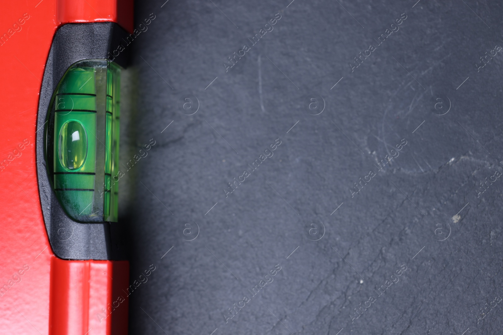 Photo of Building level on black table, top view. Space for text