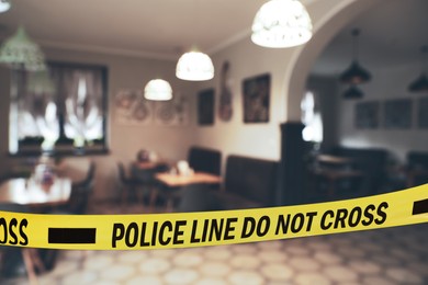 Image of Yellow crime scene tape in empty restaurant