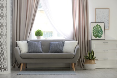 Beautiful curtains on window in stylish living room interior