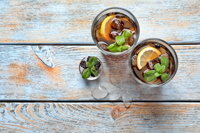 Glasses of fresh lemonade on wooden table